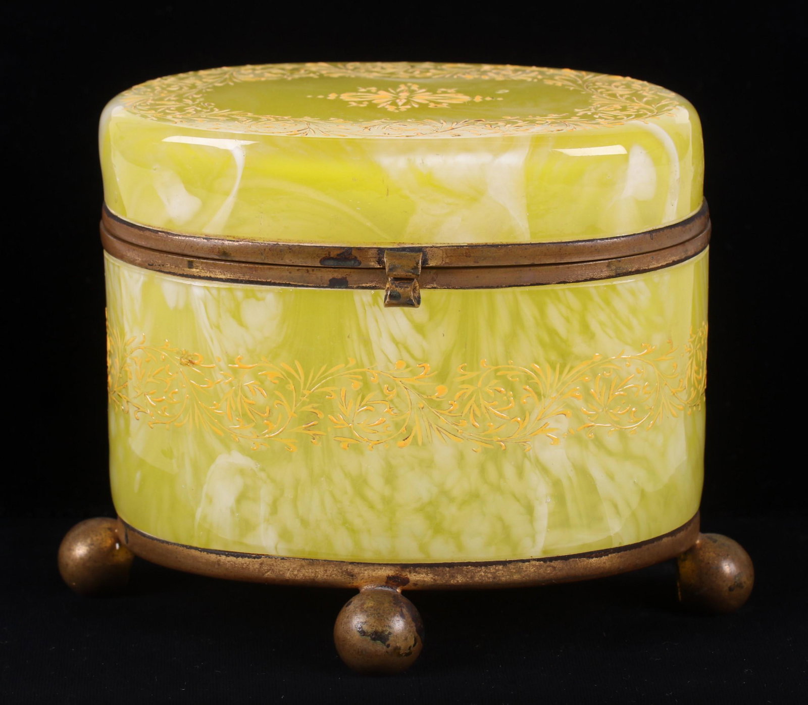 A Victorian Glass Jewelry Casket: Yellow spatter glass with applied yellow foliate decoration and ball feet. Dimensions: 6" x 4", 4 1/4" tall. Provenance: From a Pittsburgh estate.