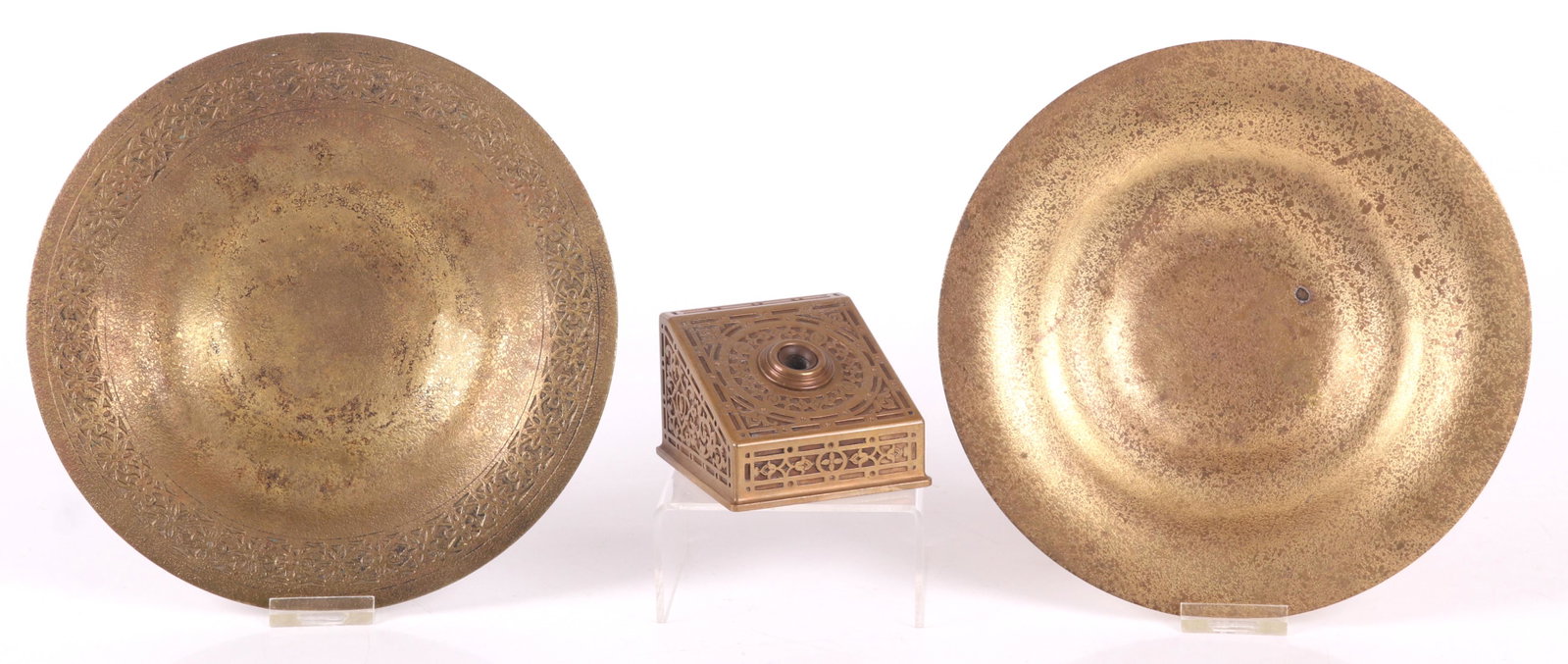 Three Pieces of Tiffany Bronze: All early 20th century and gilt. A Tiffany and Co. pen holder and a two similar acid etched bronze bowls, both marked for Tiffany Studios. Dimensions: The pen holder is 3 1/2" x 3 1/4" and 2 1/2" tall