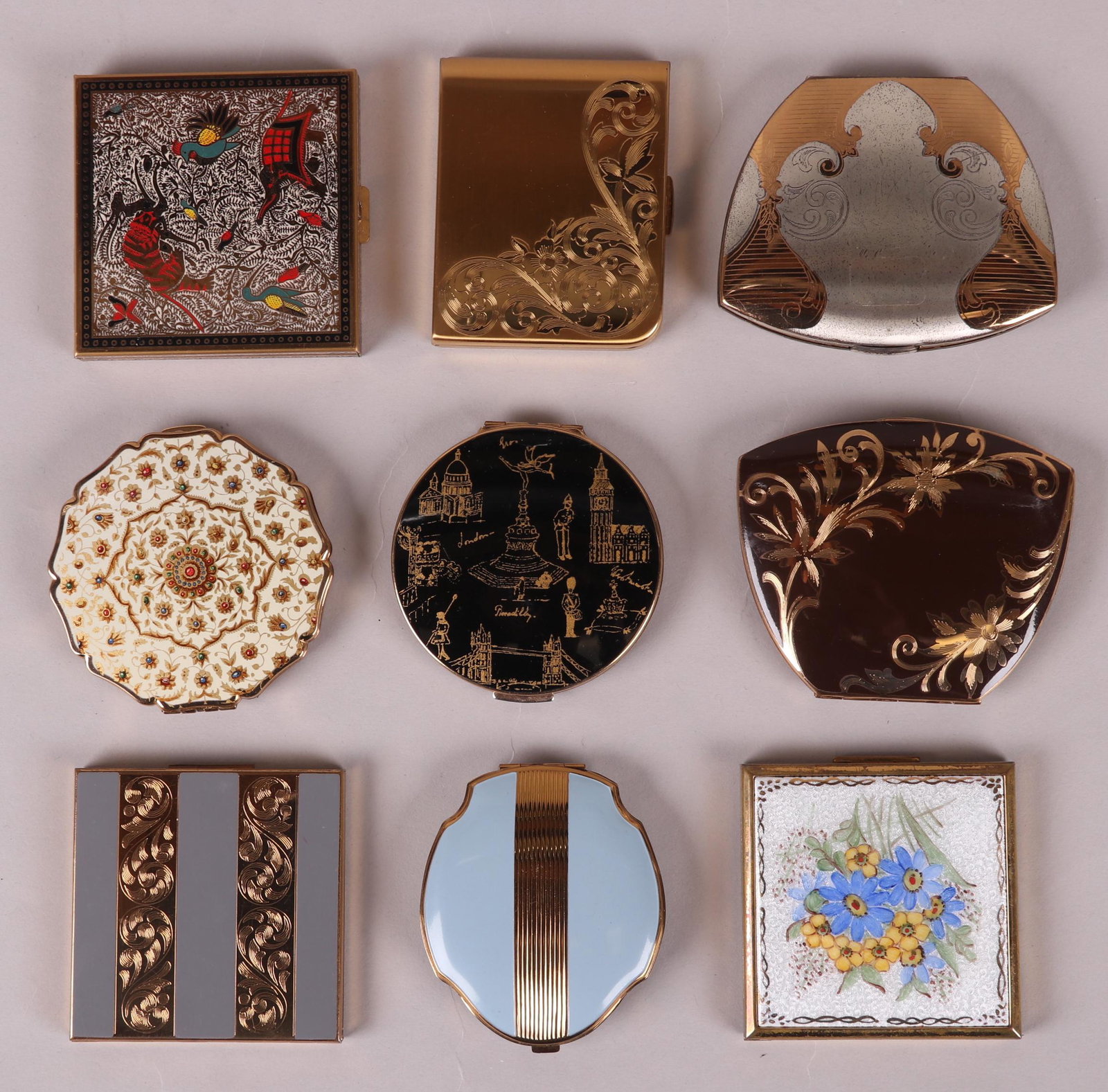 Estate Lot, A Group of Vintage Compacts: Examples by American Elgin, Volupte, and Stratton. Various forms and decoration. Dimensions: From 2 1/2" x 3" to 3 1/2" x 3". Provenance: From a Pittsburgh estate.