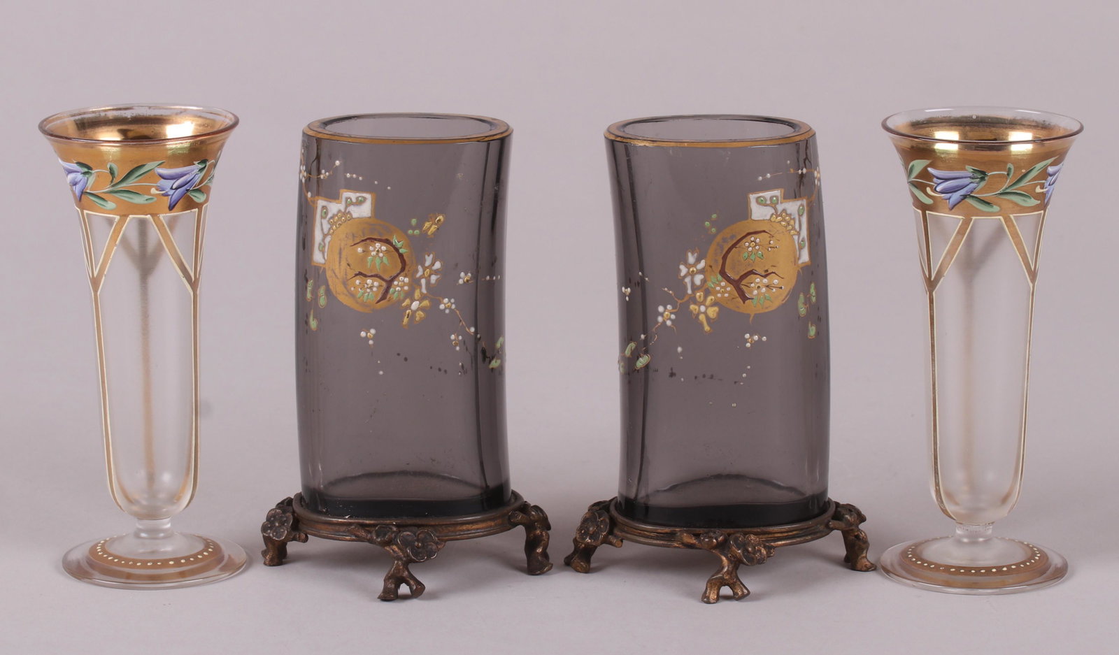Four 19th Century Enameled Glass Vases: A pair of small trumpet form glass vases with gilding and enameled flowers and a pair of smokey glass vases with Japanese style enameled decoration and ormolu bases. Dimensions: 2" in diameter and 4" 
