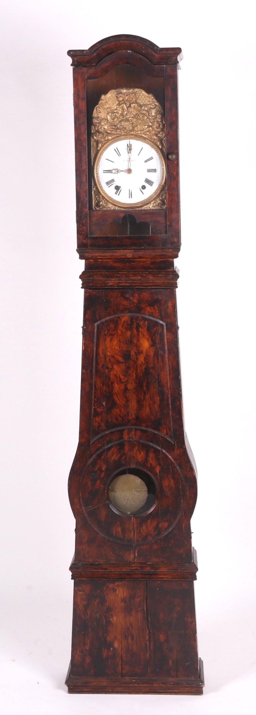 A French Grain Painted Morbier Clock: 19th century, with an enameled dial, softwood case and dog decorated pendulum. Dimensions: 16 1/2" x 8 1/4", the height is 85". Provenance: From a local collection.