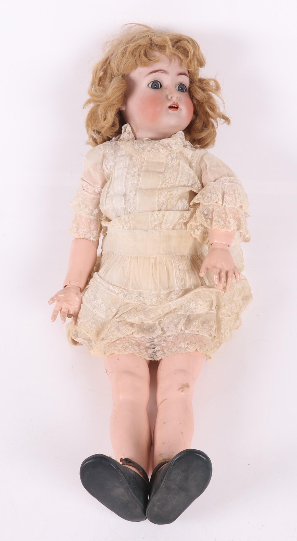 A Simon and Halbig Bisque Head Doll: A large example with a composite body, sleep eyes, open mouth and pierced ears. Dimensions: 30" tall. Provenance: From a PA estate.