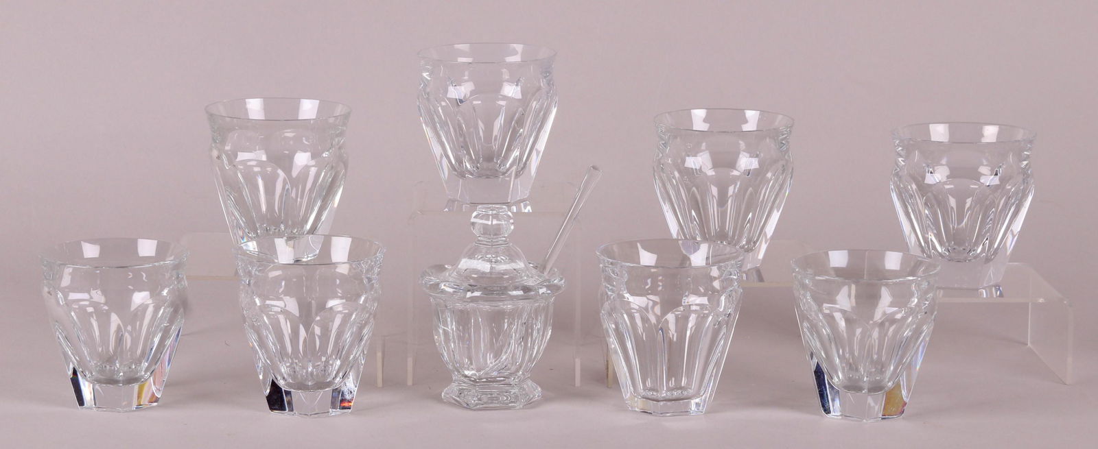 A Set of Baccarat Tumblers and a Jam Jar: A set of eight hexagonal panel cut tumblers with a jam jar and spoon, with lid. All with acid etched mark. Dimensions: Each tumbler is 3 1/4" in diameter and 3 1/4" tall, the jam jar is 3 1/4" in diam