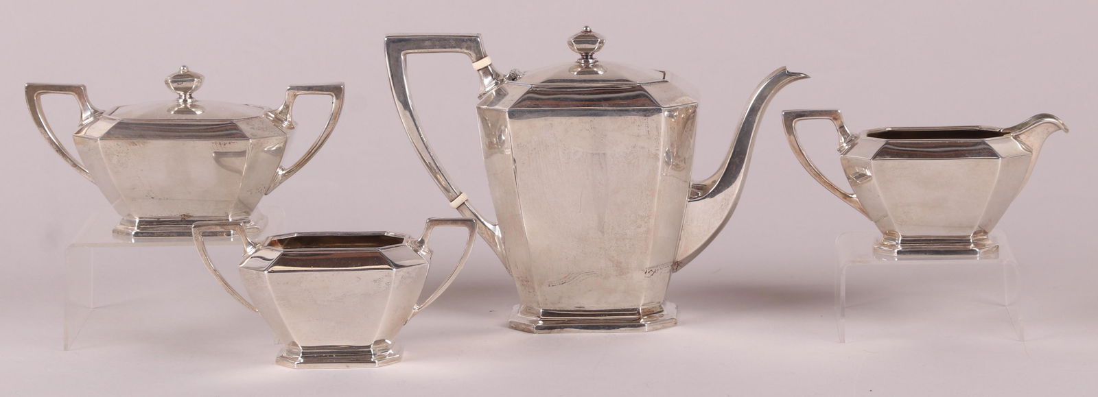 A Four Piece Sterling Silver Tea Set: By Gorham, in the Fairfax pattern. A teapot, covered sugar, open sugar and creamer. Dimensions: From 6 3/4" x 4" to 10 1/2" x 4", the heights range from 3 1/2" to 8 1/4". The total approximate weight