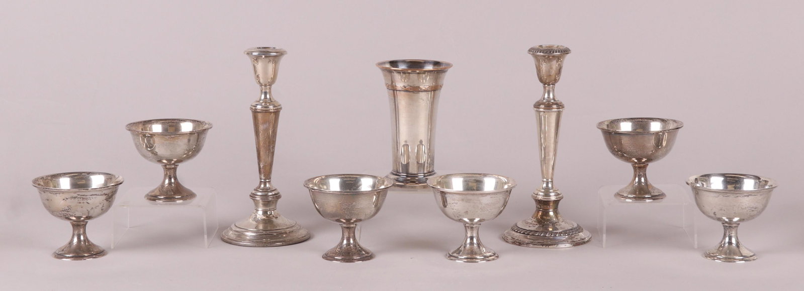 A Group of Sterling Silver Including Candlesticks: Comprising: two mismatched Gorham weighted candlesticks, a set of six berry bowls with circular molded feet and a silver plated vase/trophy inscribed, "Prince Bebbi, Juan Les Pins, I Prix". Dimensions
