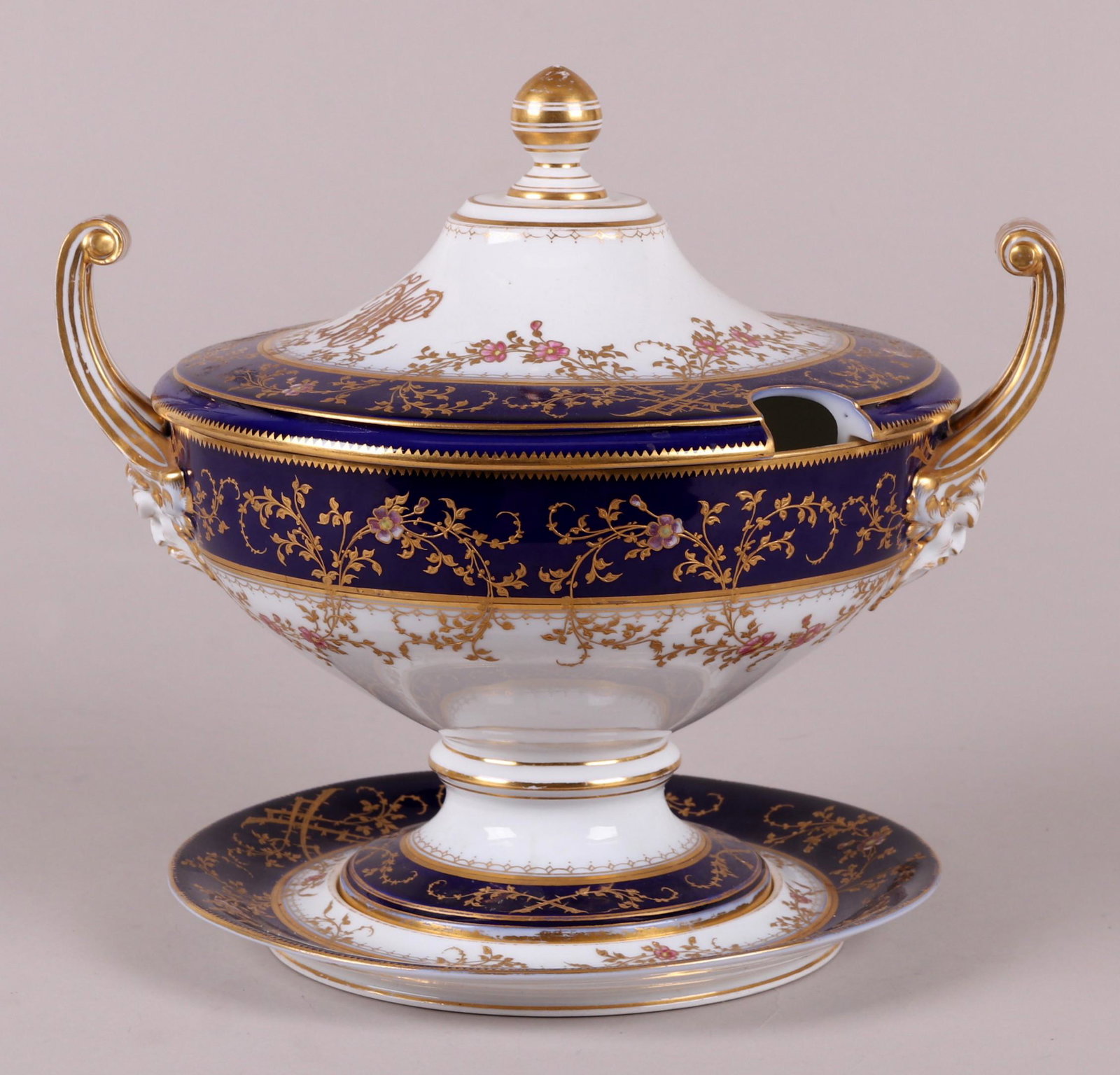 A Vienna Porcelain Tureen: Late 19th or early 20th century, marked for Wahliss. With high open and scrolled handles, cobalt blue bands and gilt floral decoration. Dimensions: 13" x 10", the height is 13". Provenance: From a Buc
