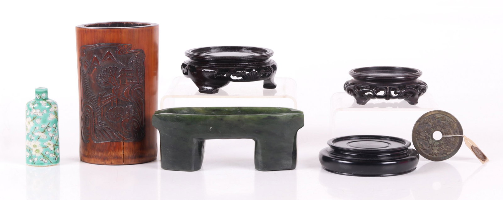 Chinese Items, Snuff Bottle, Brush Pot, Etc...: Comprising: a carved green stone ashtray, an antique bronze coin, three carved wooden stands, a bamboo brush pot with carved landscape decoration and poetry, and a prunus decorated snuff bottle. Dimen