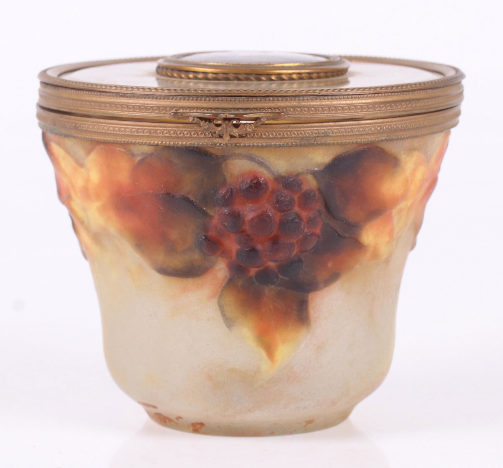 An Argy Rousseau Art Glass Box: Circa 1920, an unusual Pate-de-Verre example with an ormolu mounted lid that features a Limoges enameled roundel decorated with a portrait of a beauty in profile signed "L.C.". The box is signed at th