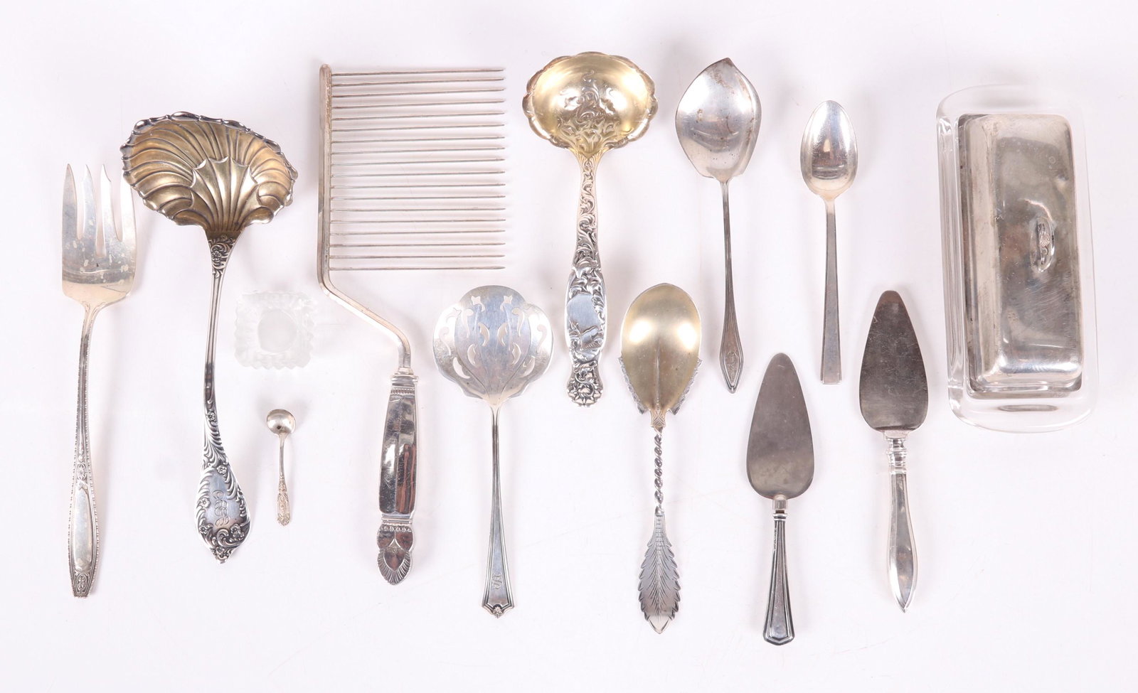 A Group of Sterling Tableware: Comprising: an angel food cake knife by Drank M. Whiting, a ladle by Towle, a salad serving fork by Wallace, an unmarked circa 1870 sugar shell, a butter server with sterling cover by Fisher and a gla