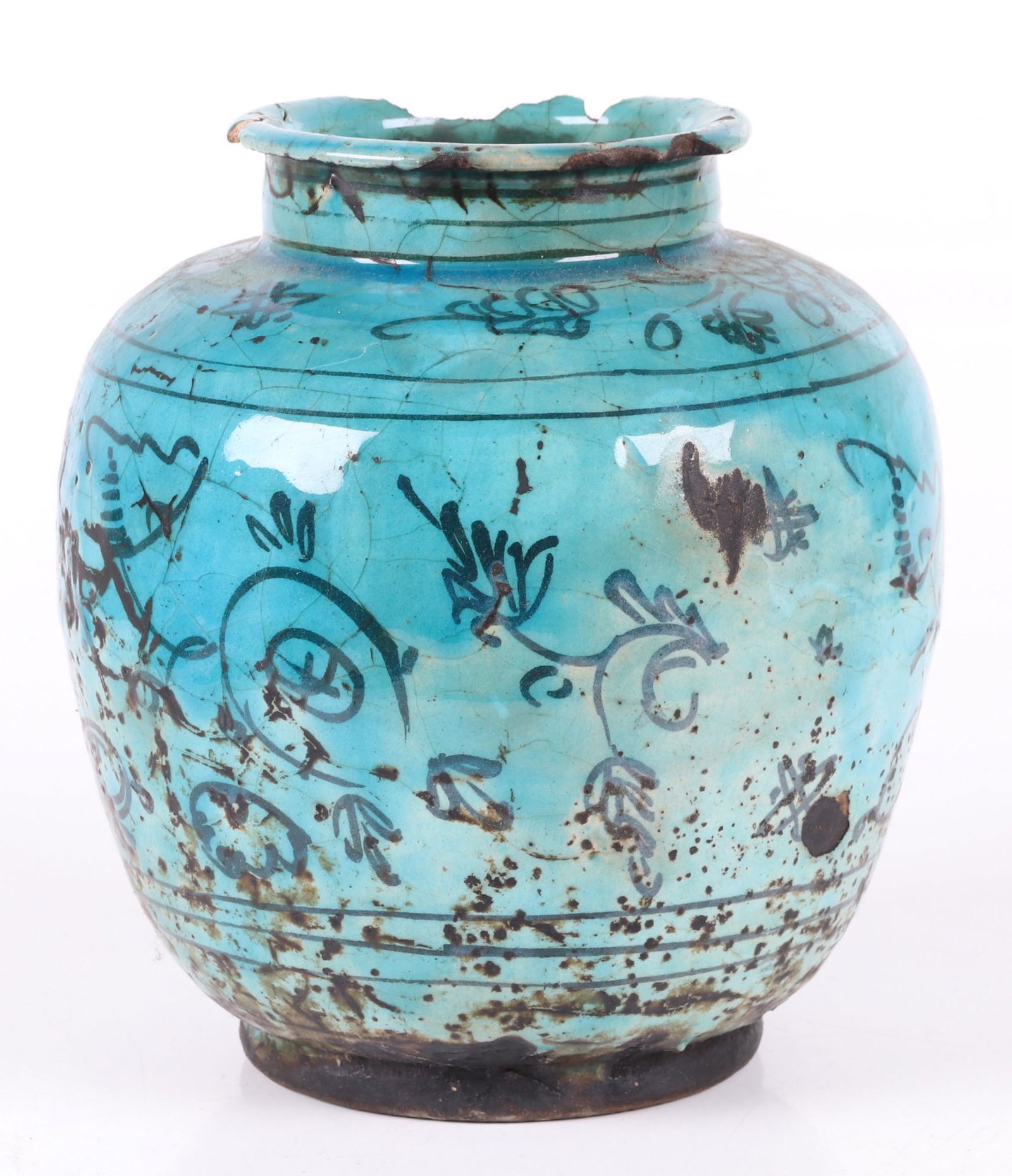 An Antique Persian Pottery Jar: 19th century or earlier, with repeated floral decoration in black and a turquoise glaze. Old Kevorkian collection sticker as pictured. Dimensions: 7" in diameter, 8 3/4" tall. Provenance: From a PA es