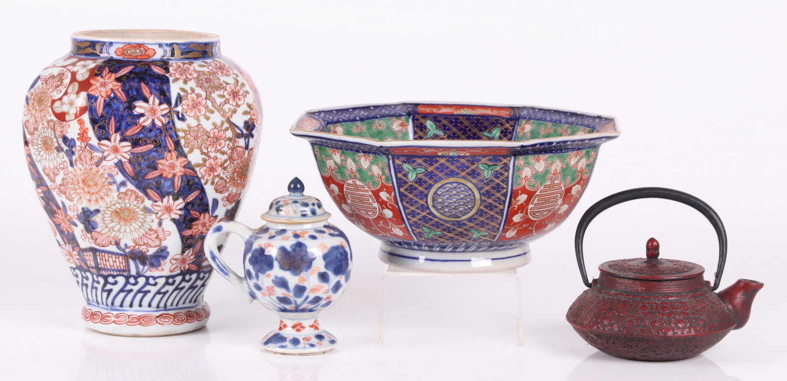Japanese Items, Imari, Cast Iron: Comprising: an Imari floral decorated vase, an Imari octagonal bowl, an early imari covered pot with single handle and a cast iron teapot with floral decoration and a bail handle. Dimensions: From 4" 
