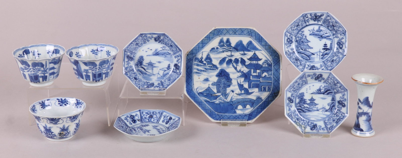 A Group of Chinese Blue and White Porcelain: All Qing Dynasty, a pair of cups, a single cup, a small vase , a set of four dishes and a Canton octagonal trivet. Dimensions: From 1 3/4" to 6" in diameter, the heights range from 1" to 3 3/4". Prove