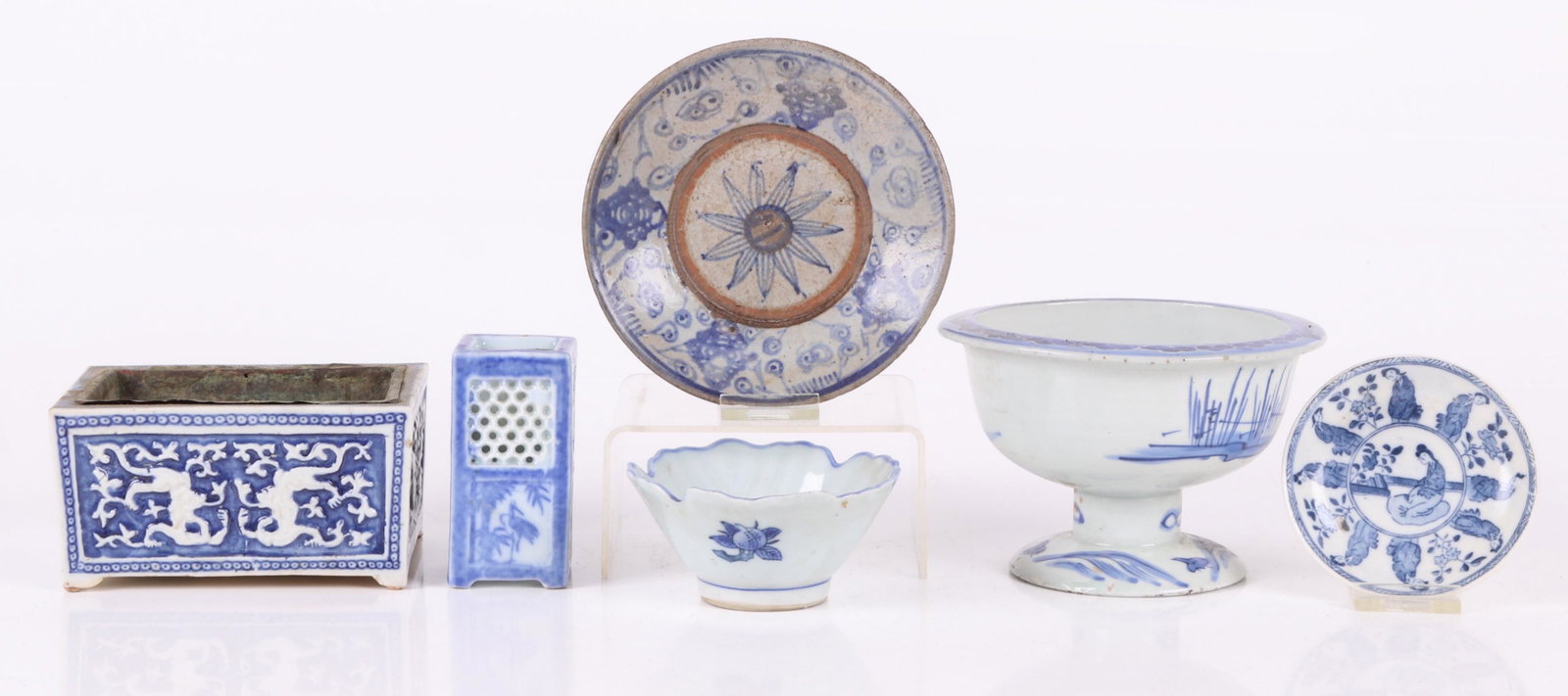 A Group of Chinese and Japanese Porcelain: Comprising: a Ming Dynasty plate made for the Southeast Asian market, a Japanese blue and white footed bowl, a small Japanese reticulated vase, a Japanese blue and white leaf form bowl, a small Chines