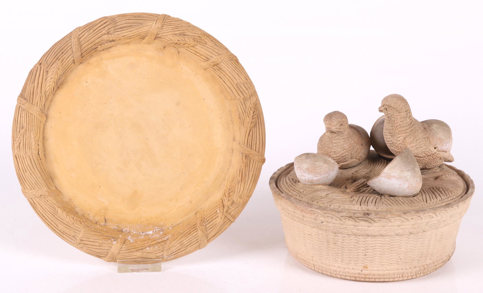A Continental Earthenware Covered Dish: 19th century, likely French, basket form with a cover that is decorated with chicks emerging from eggs. With associated undertray. Dimensions: The tray is 9 1/2" in diameter, the dish is 7 1/4" in dia