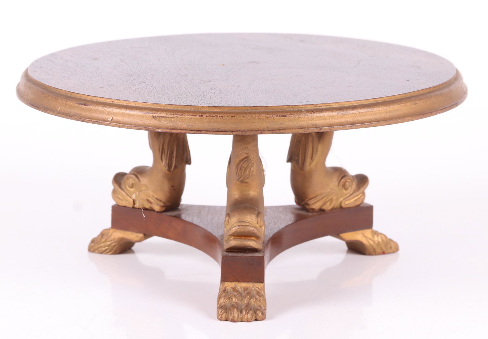 A Salesman Sample Size Empire Table: Mahogany, with paw feet and dolphin supports below a molded circular top. 20th Century. Dimensions: 10 1/2" in diameter, 5" tall. Provenance: From a PA estate.