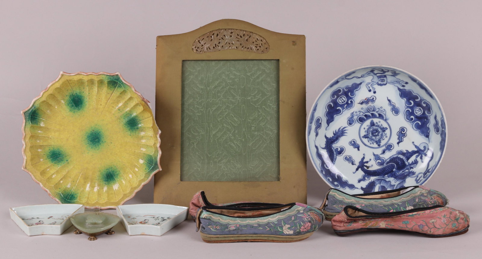 A Group of Chinese Items Including Porcelain: All 19th or early 20th century, comprising: two famille rose segments form a larger food server, a carved green stone tray with an ormolu base, a yellow glazed scalloped dish with green spots, a blue 