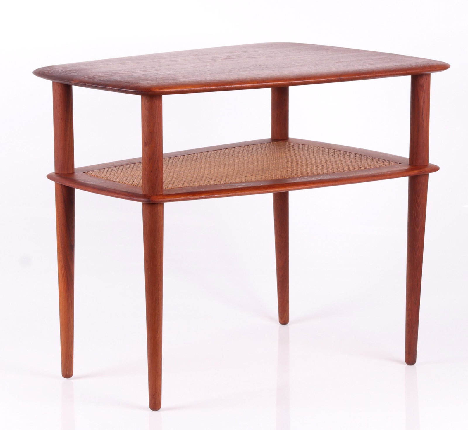 John Stuart Teak Side Table: Mid 20th century, with tapered cylindrical legs, low rattan covered shelf and and conforming top. With badge as pictured. Dimensions: 28" x 20 1/2", 23" tall. Provenance: From a local estate.