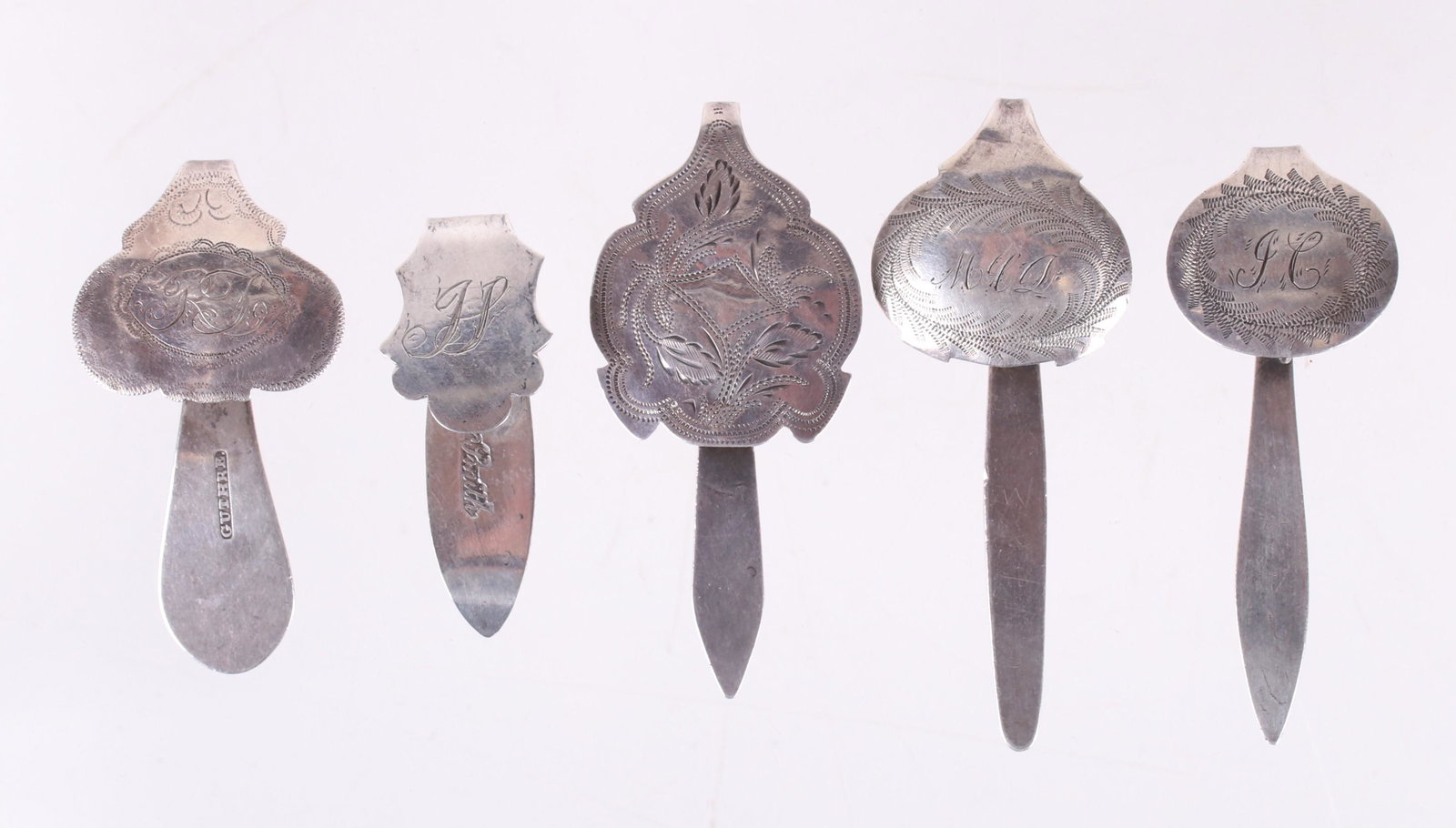 Five American Coin Silver Chatelaine Hooks: Examples by James Guthre (Wilmington, DE) , Lewis and Smith (Phila.) and three unsigned examples. All early 19th century, all but one features engraved decoration. Dimensions: From 1 3/4" to 2 1/2" lo