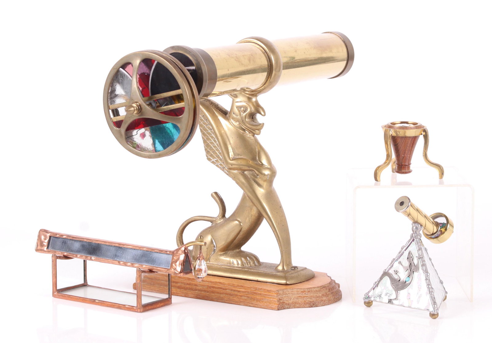 Four Modern Kaleidoscopes: Various forms and materials including brass, copper and glass. Dimensions: From 3" in diameter to 9 1/2" x 14", the heights range from 2 1/4" to 10 1/2". Provenance: From a local collection.