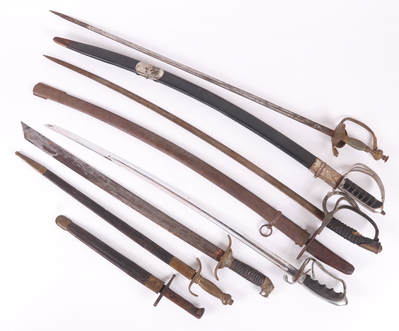 A Group of Swords and Bayonets: 19th and 20th century, comprising: a bayonet marked, "Terni", an unmarked Continental bayonet with brass grip, a Solingen blade with a brass lion head pommel, an unmarked rapier, a "Golden Temple" dec