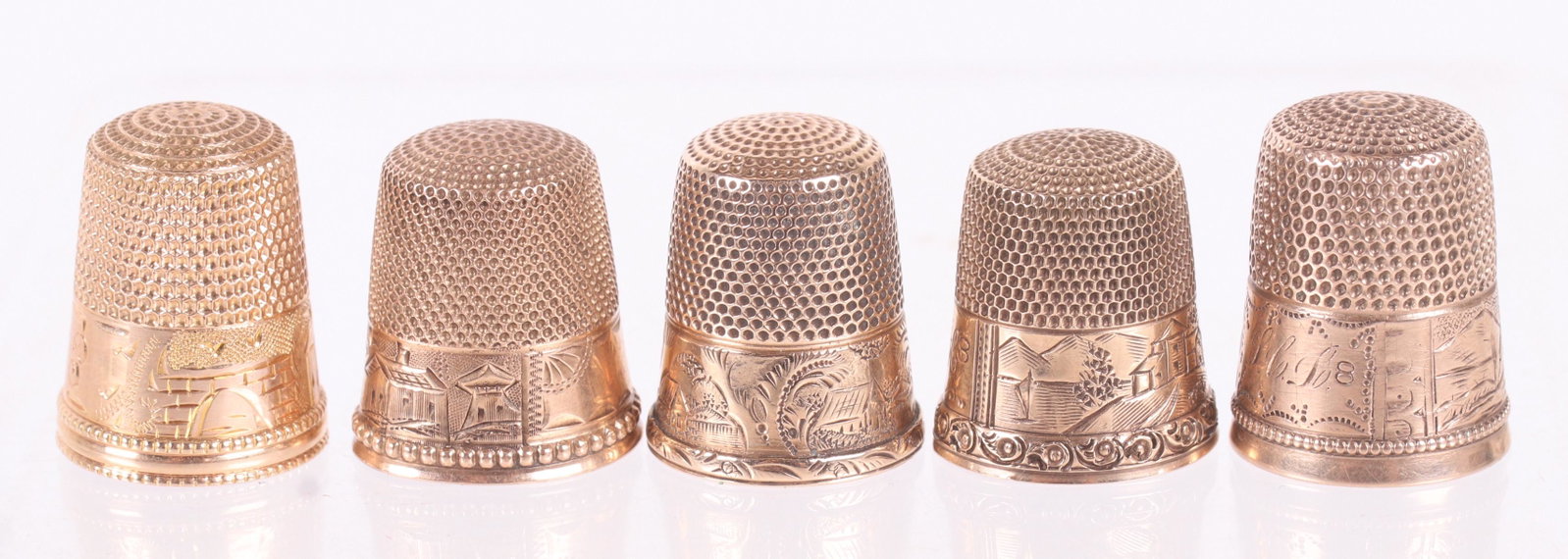 Five Landscape Decorated 10k Gold Thimbles: All late 19th or early 20th century, each with engraved landscape decoration. Dimensions: The total approximate weight is 10.4 dwt. Provenance: From a local estate.