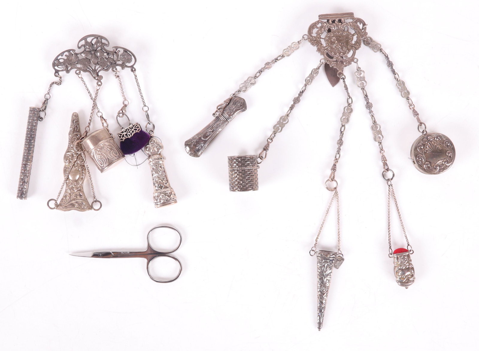 Two Sterling Chatelaines: Both circa 1900 and later. One is a chatelaine hook with hallmarks for London and the year 1921, the other is a pin circa 1900 and simple marked "sterling". Several of the implements are not sterling.
