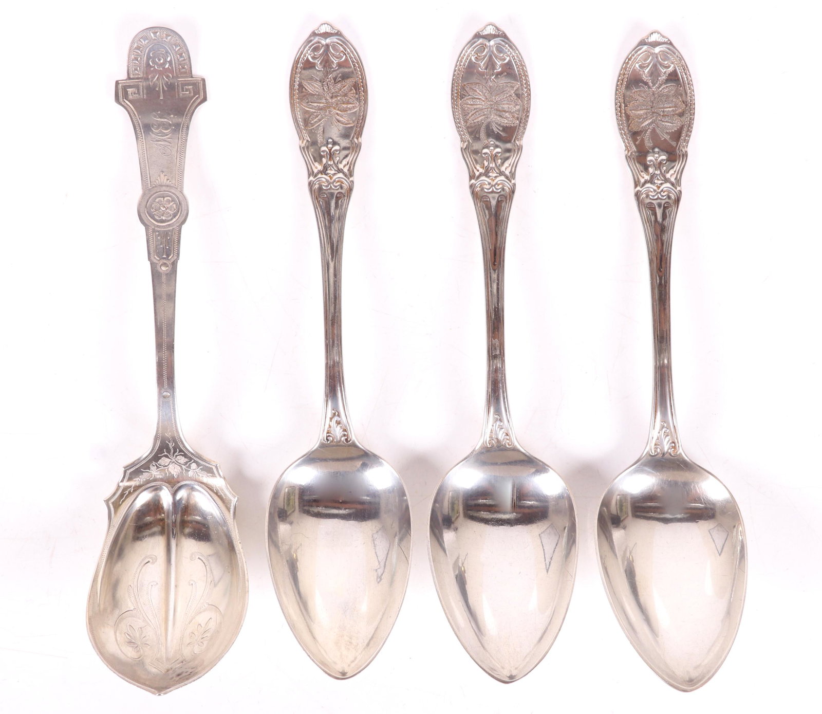 Four American Coin Silver Serving Spoons: A serving spoon by James Watts with the retailer mark for James P. Butler, and three serving spoons marked for James Watson. Dimensions: From 8 1/2" to 8 3/4" long. The total approximate weight is 7.8