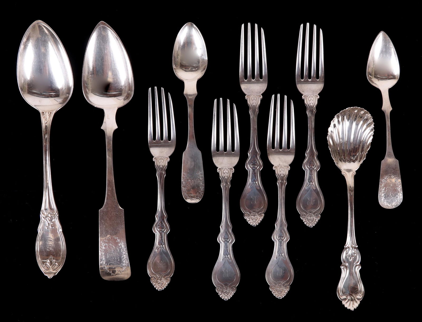 Ten Pieces of Philadelphia Coin Silver Flatware: Comprising: Five Champney and Smitton 7" forks, a 6 3/4" sugar shell by Annin and Dreer, an 8 1/2" serving spoon by Butler and McCarty, an 8 7/8" serving spoon by John Fries in a Wreath pattern, a 6"