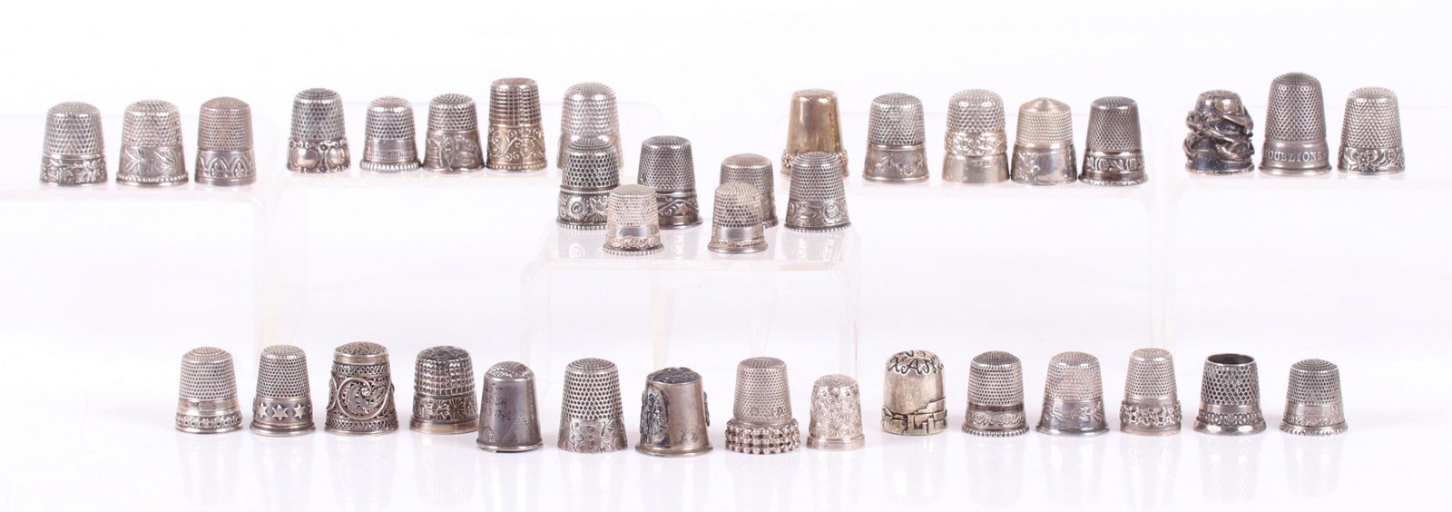 Thirty Seven Sterling Silver Thimbles: Various sizes and decoration, makers include Simons Brothers Webster Co., and Ketcham and McDougall. Dimensions: From size 6 to 12. The total approximate weight is 5.56 troy ounces. Provenance: From a