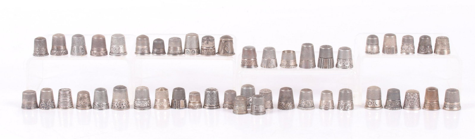 Forty Seven Sterling Silver Decorated Thimbles: Various sizes and decoration, makers include Simons Brothers, Waite, Thresher Co., and Ketcham and McDougall. Dimensions: From size 5 to 11, the total approximate weight is 6.5 troy ounces. Provenance