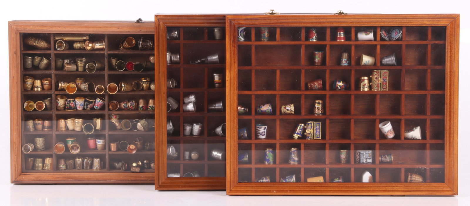 A Large Group of Thimbles, Brass, Etc...: Approximately 100 brass examples, approximately 75 pewter thimbles, and another large group of about 60 thimbles in various materials and decoration including cloisonne. Dimensions: The cases range fr