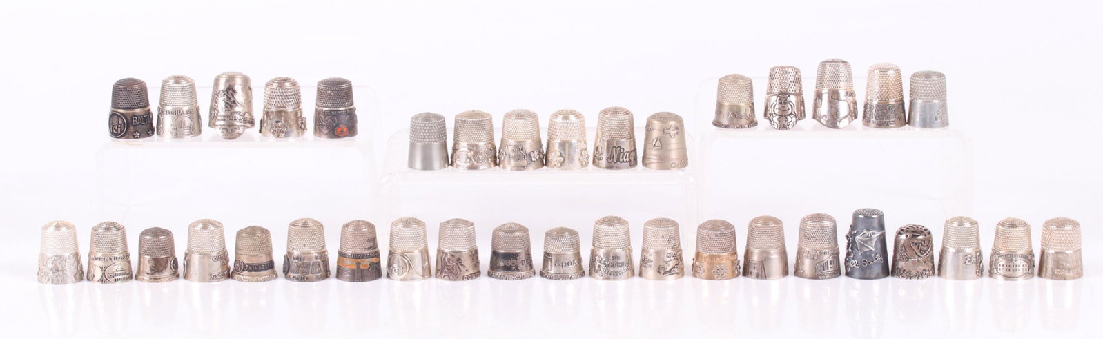 A Large Group of Sterling Thimbles, TCI Conventions: Thirty five thimbles, most souvenirs of various Thimble Collectors International conventions (years range from 1978 to 2018) and two pewter examples. Dimensions: The total approximate weight of the st