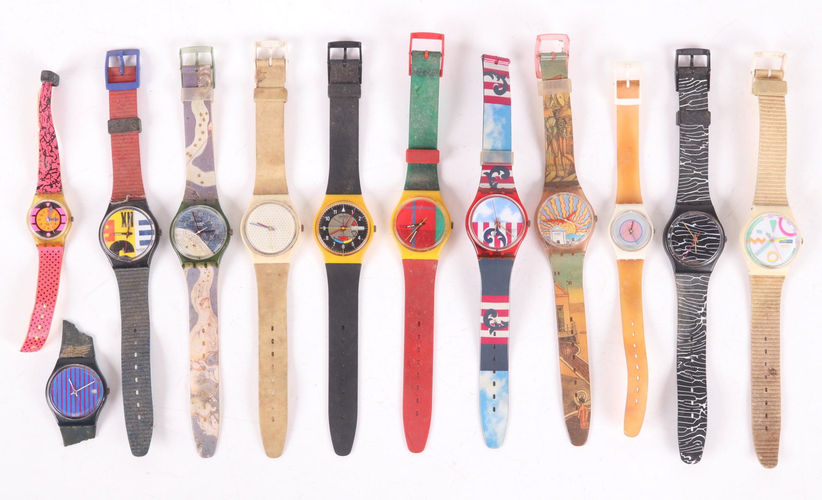 A Group of Swatch Swiss Watches: Twelve examples, no boxes, all need cleaning and have wear. Some bands are missing, cracked or in otherwise poor condition. We cannot guarantee functionality. Dimensions: From 6" to 9" long.