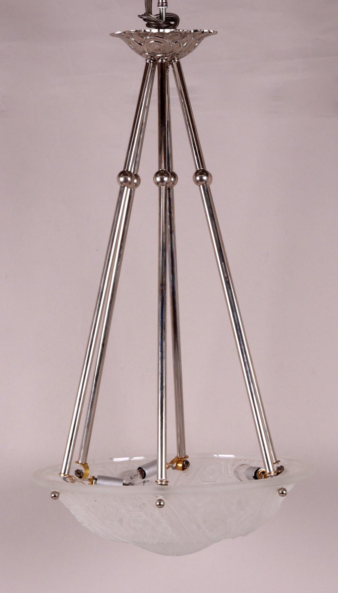 A Muller Freres Style Glass Fixture: An art deco style example with a frosted dome decorated with stylized foliate and floral decoration and chrome supports. Dimensions: The shade is 16" in diameter and the total length is 30". Provenanc