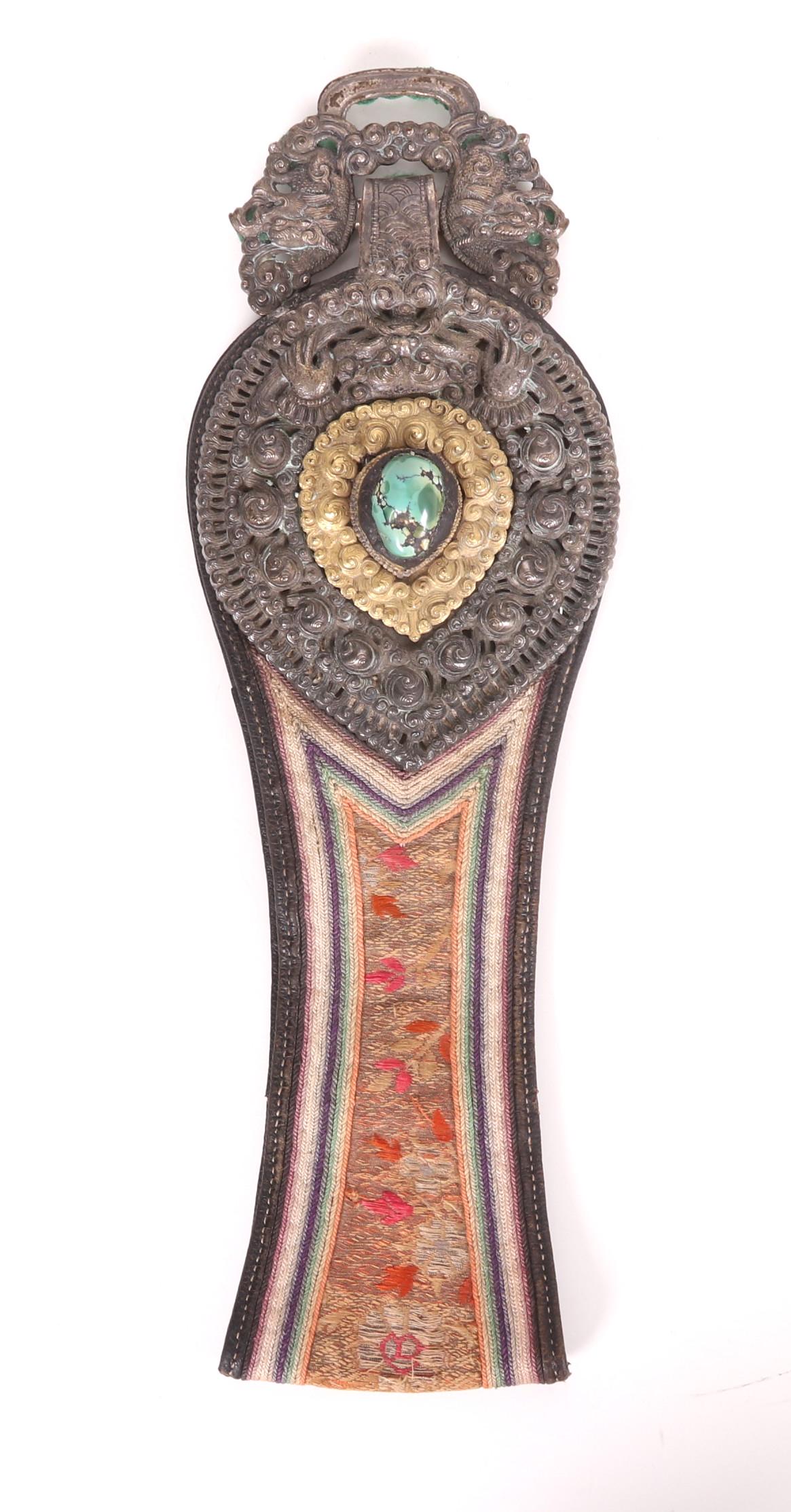 A Tibetan Silver and Silk Belt Ornament: Parcel gilt silver with silk and inset turquoise. Dimensions: 13" x 4". Provenance: From a Main Line estate.