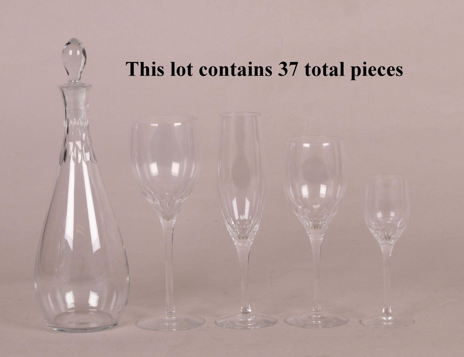 Orrefors Crystal Prelude Stemware: Thirty-seven pieces. Containing one 11.5" decanter, thirteen 8.4" water goblets, thirteen 7.5" wine goblets, six 8.5" champagnes, and four 5.75" cordials. Not signed. Dimensions: Tallest measures 11.5