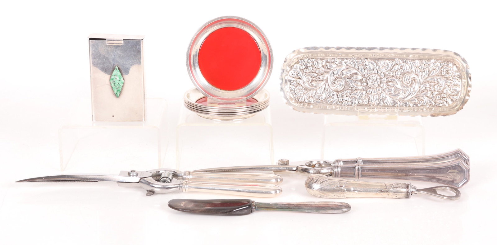 A Group of Sterling Estate Items: Comprising: an oval repousse tray, a set of six coasters by Towle, a pistol handled (loaded) bottle opener, two pairs of sterling handled (loaded) grape shears, a jade mounted cigarette box case,and a