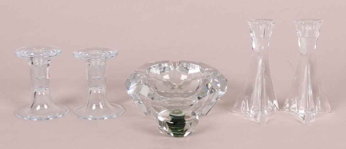 Glass & Crystal, Including Baccarat: Including a large Baccarat crystal faceted ashtray, a pair of Holmegaard candlesticks, two unmarked modern crystal candlesticks, and a signed faceted art glass paperweight. Dimensions: The Baccarat as