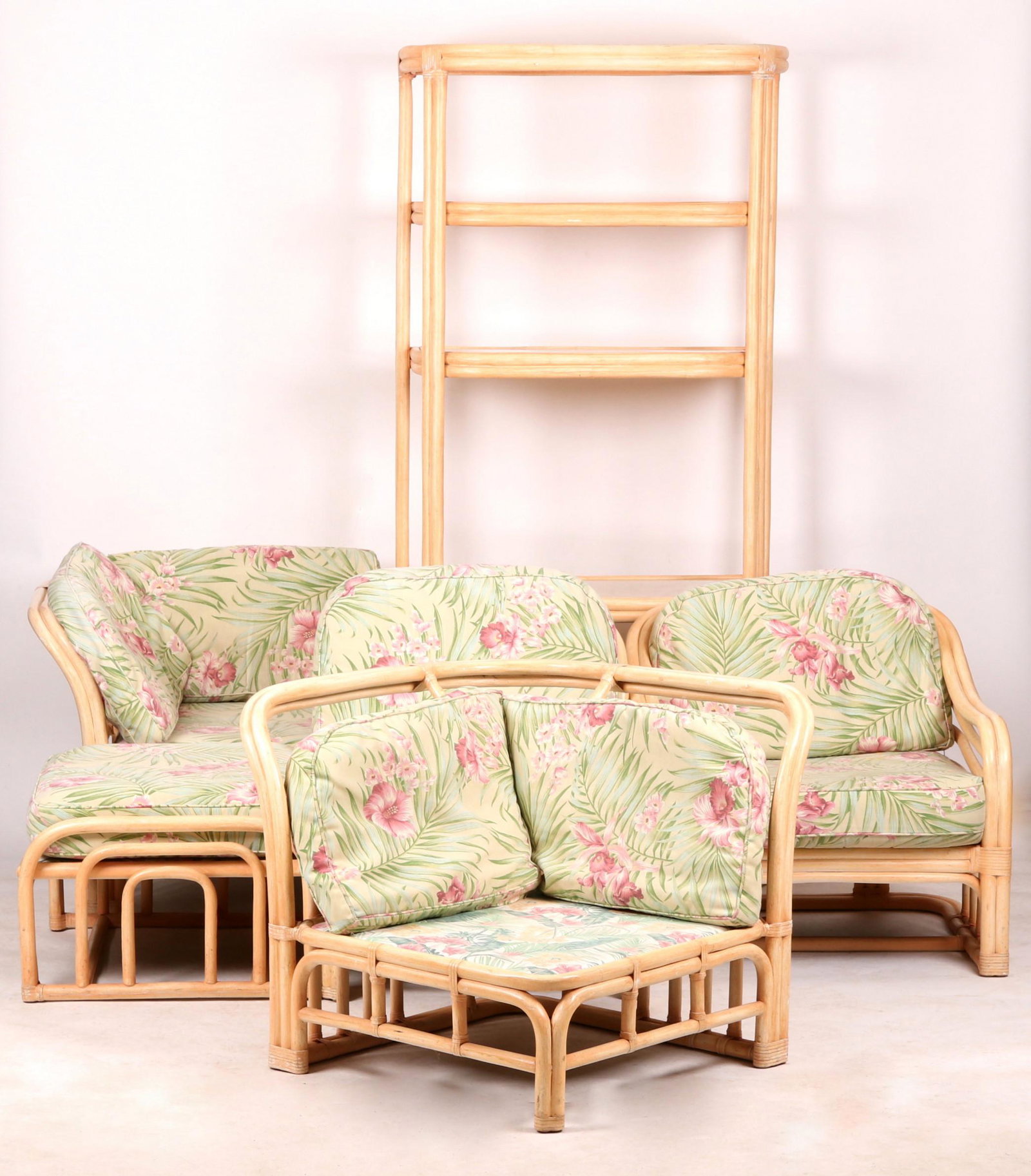 Brown Jordan Rattan Furniture Set: Late 20th century, with floral upholstered cushions, the etagere having glass shelf inserts. Dimensions: The etagere measures 78" H x 36" W x 16" D. The chairs measure approximately 28" H x 30" W x 30