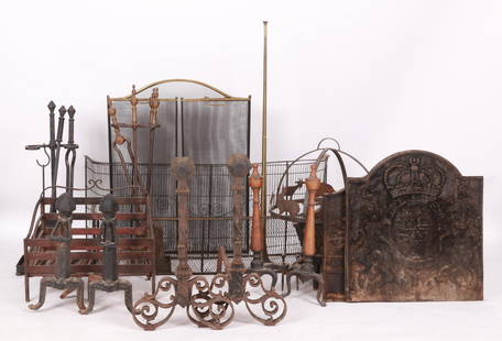 A Large Group Of Fireplace Accessories: Three pairs of andirons, two sets of tools, a wood bin, a fox hunt trumpet, three screens, a large log bin, hanging pot rack, a decorated with animals, and two firebacks. 19th & 20th century. 