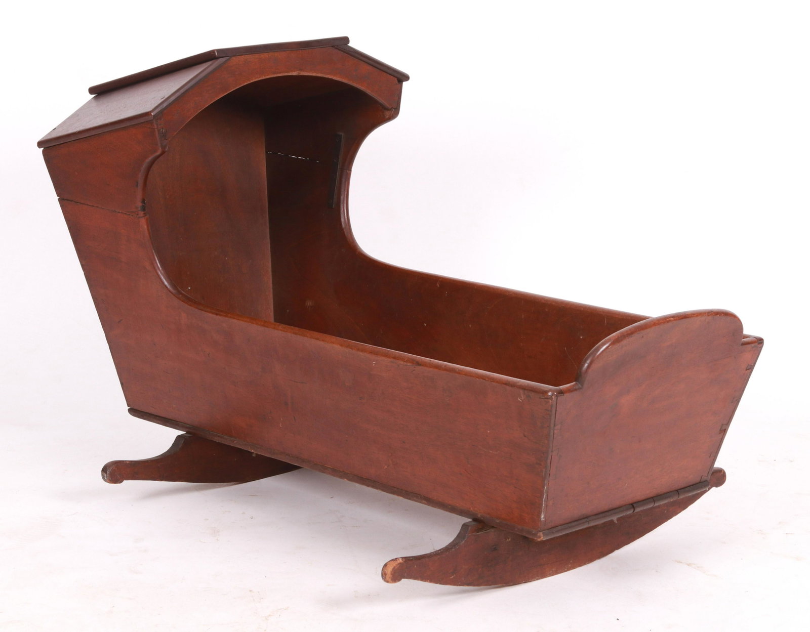 A Pennsylvania Hooded Walnut Cradle: First half of the 19th century, of typical form. Dimensions:38" L x 19" W x 26.5" H Provenance:From a local collection.