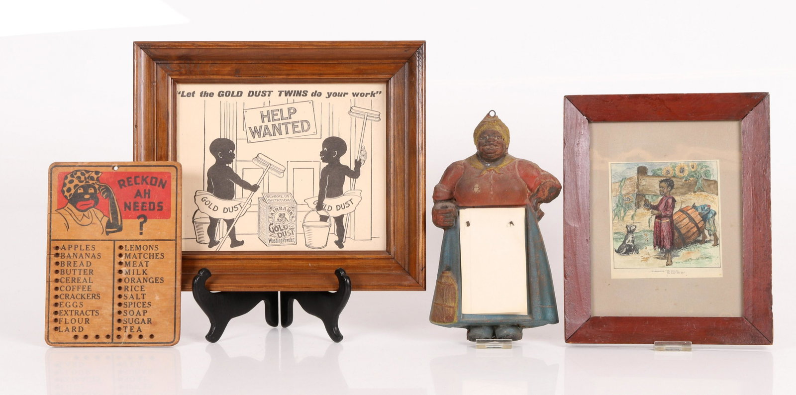 A Group of Black Americana: Comprising: a molded composite Mammy notepad holder, a hand colored print depicting two children and a dog, a grocery list board, and a Gold Dust Washing Powder framed ad. Dimensions:From 8" x 6" to 1