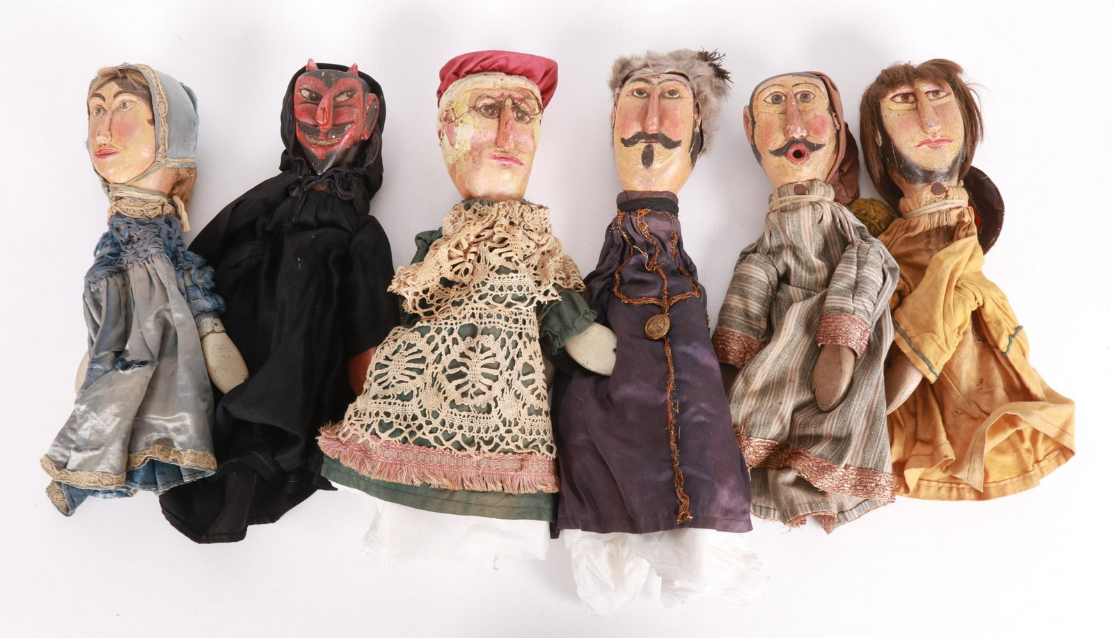 Six WPA Puppets: Painted wood head and hands, original clothing. Not marked. Dimensions:Each is about 14" H. Provenance:From a local collection.