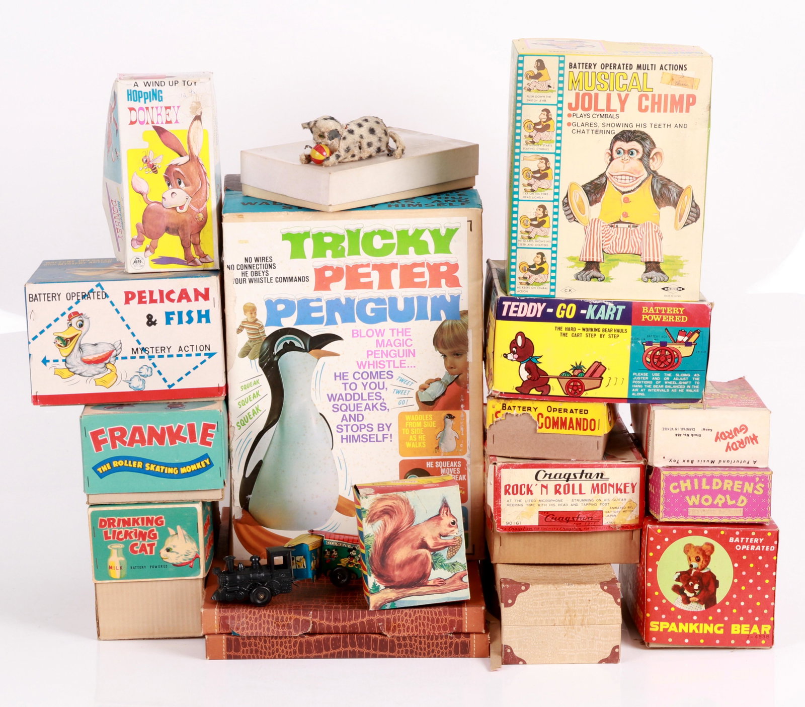 A Large Group Of Mid 20th Century Toys: Many Japanese, mechanical, battery operated, tin lithographed, ca. 1950-1970, most retaining the original box. Dimensions:From 9" x 6" x 3" to 12" x 11" x 17". Provenance:From a local collection.