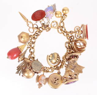 A Gold Filled Charm Bracelet: An antique charm bracelet with 19 charms, one oval charm marked 14k. Dimensions:7" long, the total approximate gross weight is 34.3 dwt. Provenance:From a NJ collection.