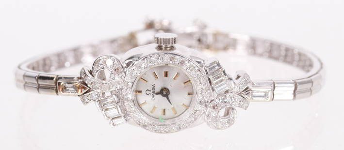 A Ladies White Gold and Diamond Wristwatch: Mid 20th century, the case decorated with diamonds. This is an Omega quartz watch. With single and baguette cut diamonds, .65 total diamond weight. Dimensions:The approximate gross weight is 8.7