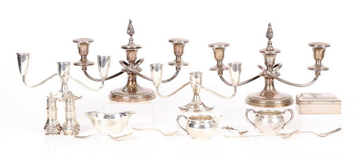 A Group of Sterling Tableware: All 20th century, comprising: a pair of repousse decorated shakers, a candy dish marked for the Acme company, a creamer and sugar set by Newport, a wood lined cigarette box by Gorham, a pair of three