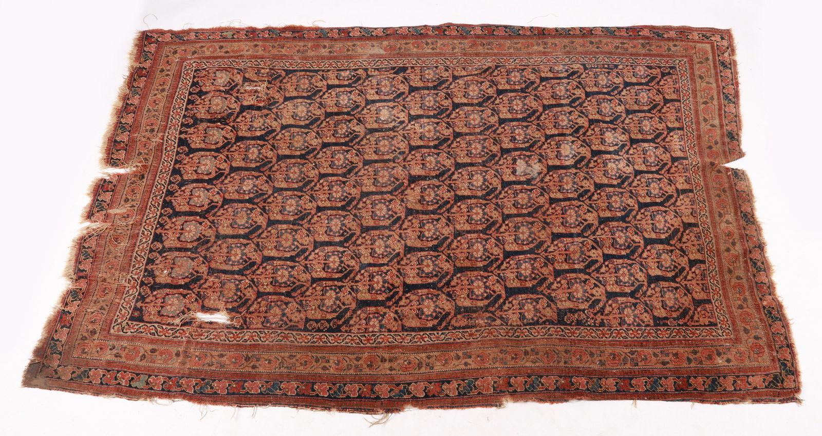 An Antique Persian Rug: Circa 1900, with a blue field decorated with a repeated floral motif, the border with floral vine decoration. Dimensions:92 1/2" x 63". Provenance: