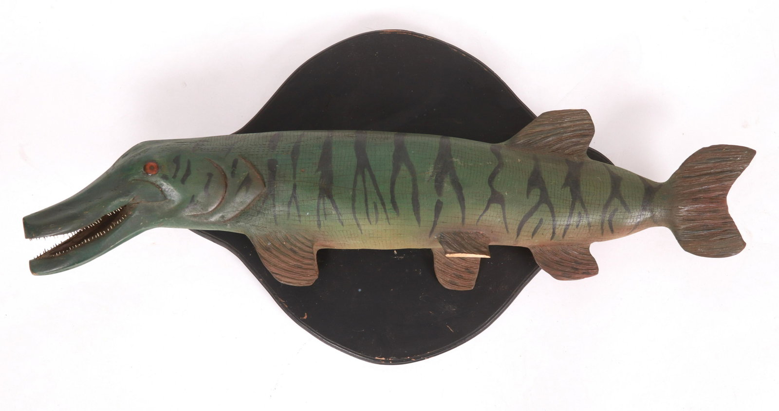 A Large Folk Art Carved Gar Fish: From the first half of the 20th century, carved wood, hand painted and with applied metal teeth, unmarked. Dimensions: 44 1/2" x 25", the depth is 9". Provenance: From a New Jersey collection.