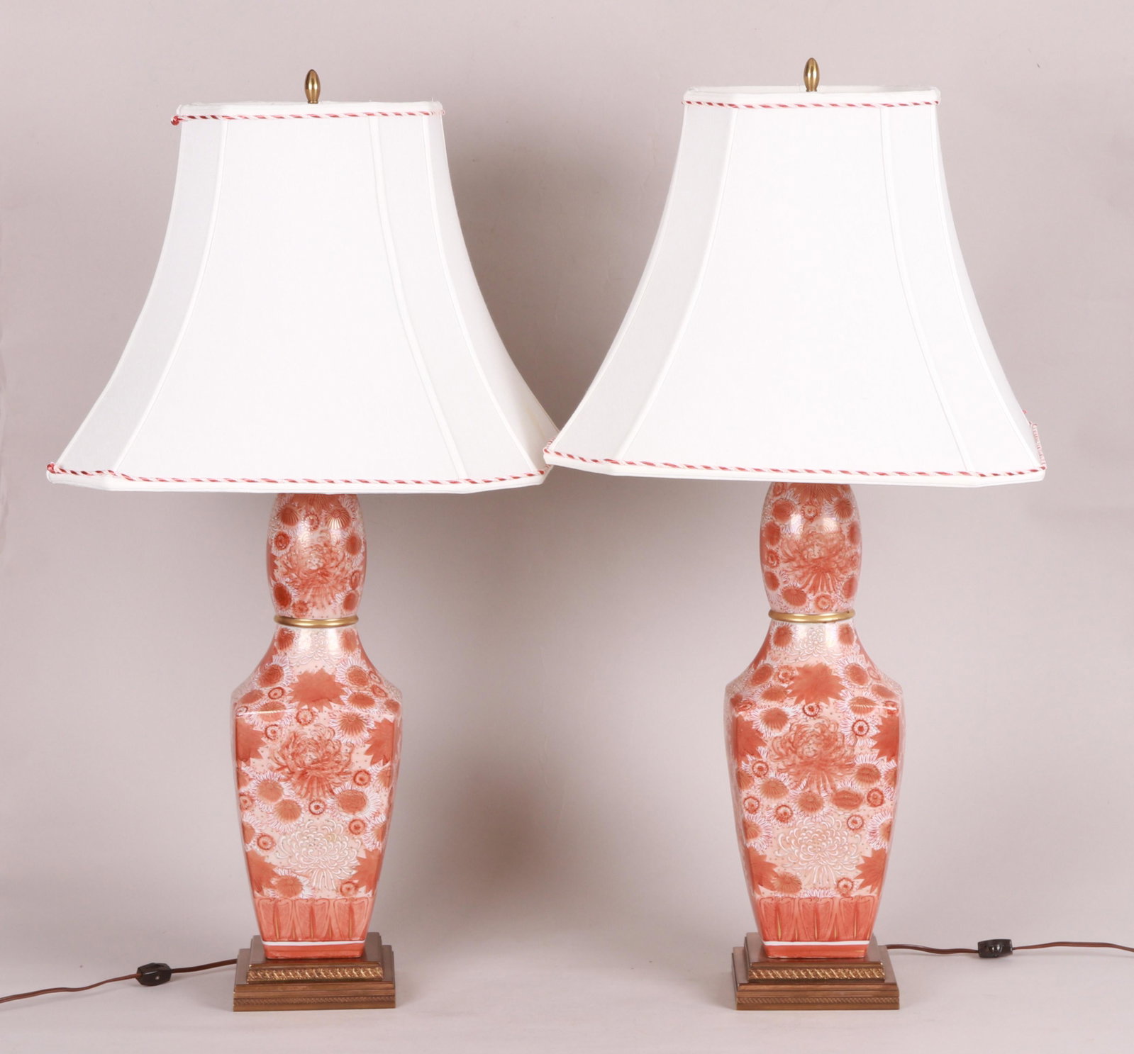 A Pair Of Kutani Porcelain Lamps: 20th century, each with two sockets and on square brass bases, with custom shades. Dimensions: 36" H to the top of the finials. Each shade is 19" x 19" x 15" H. Provenance: From a Main Line collection